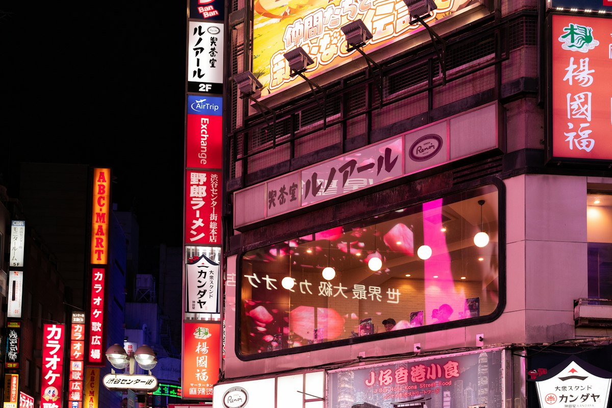 A neon-lit city street at night, evoking the futuristic world of Blade Runner 2049